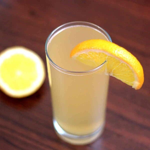 Overhead view of Alamo Splash drink in tall glass with orange slice