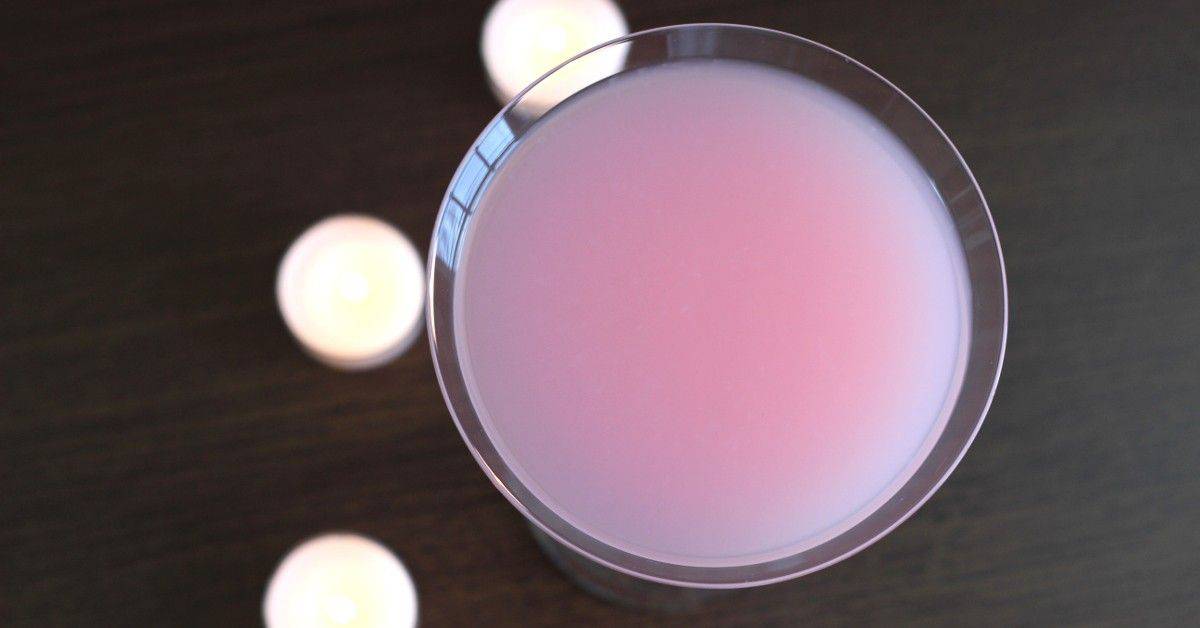 Angel's Delight drink on table with tea light candles