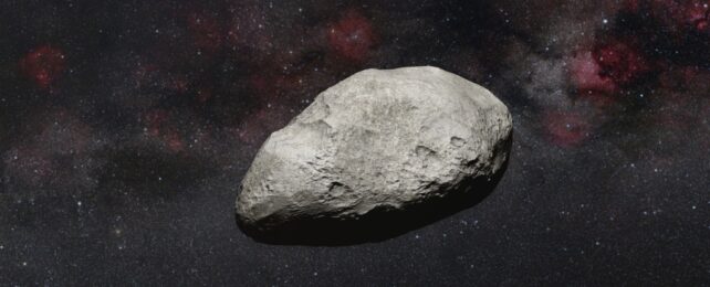 An illustration of an asteroid on a background of a starry night sky.