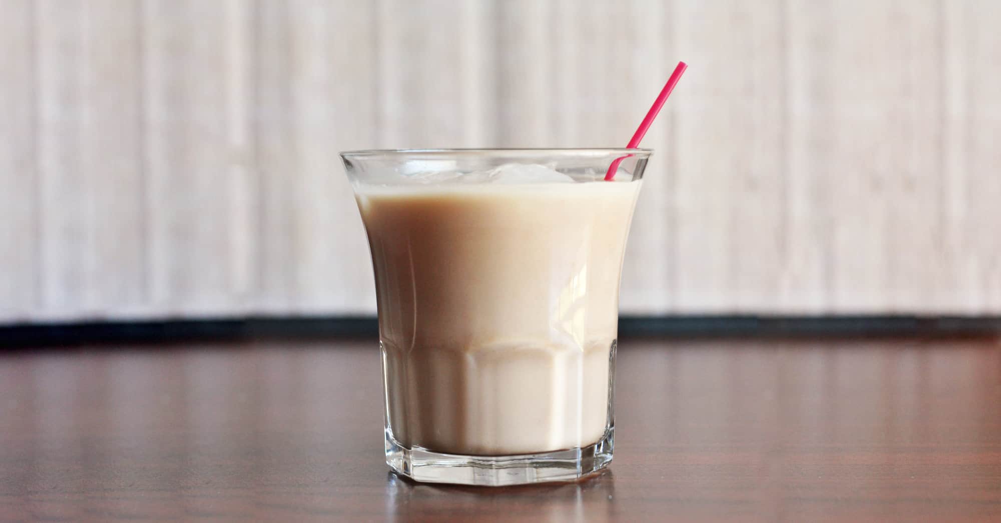 Avalanche Cocktail on table with red straw