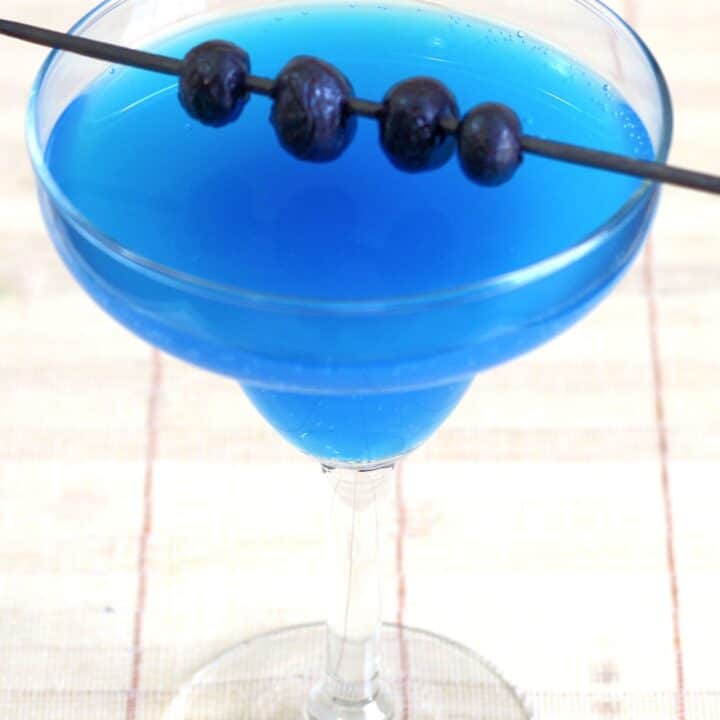 Bright blue Avartini Cocktail with blueberries