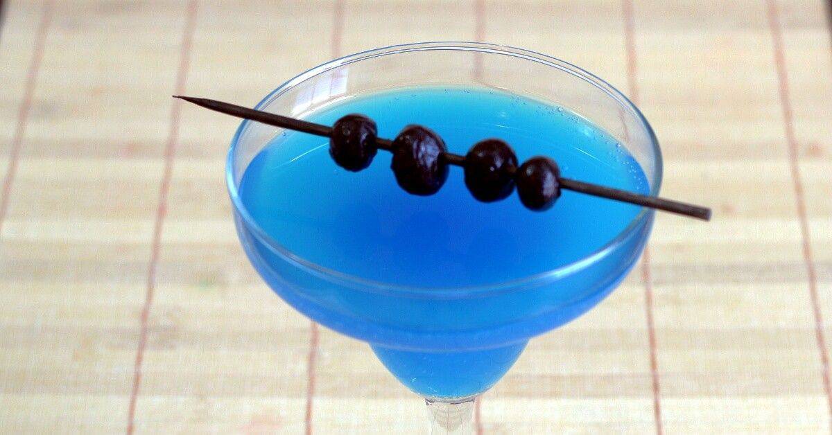 Bright blue Avartini Cocktail with blueberries