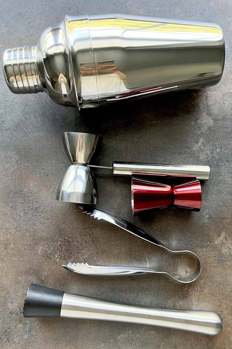 Several cocktail mixing tools laying on table