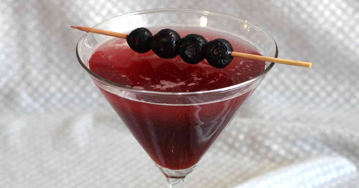 Berry Fusion Martini with blueberries on cocktail pick