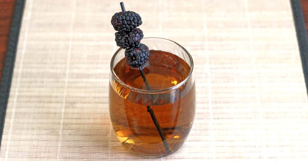 Black Cactus drink with blackberry garnish