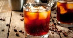 Black Russian drink on table with coffee beans