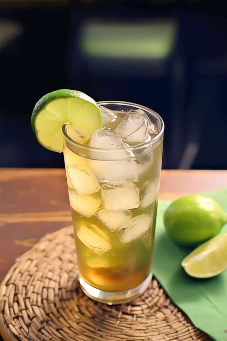 Bourbon and Sprite cocktail with lime slice on table