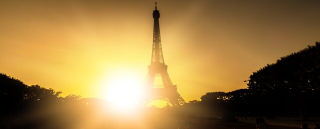 Bright sun behind Eiffel tower