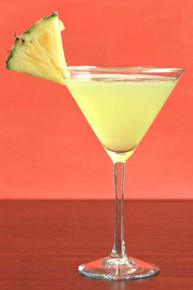 Bright yellow Cabo drink with pineapple wedge