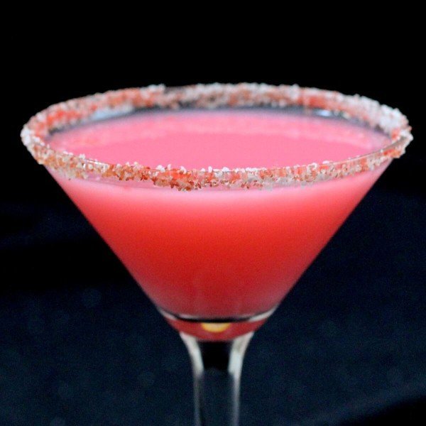 Closeup view of Candy Cane Cocktail with candy cane rim