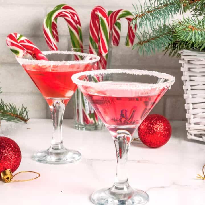 Two Candy Cane Martini drinks with candy cane garnish