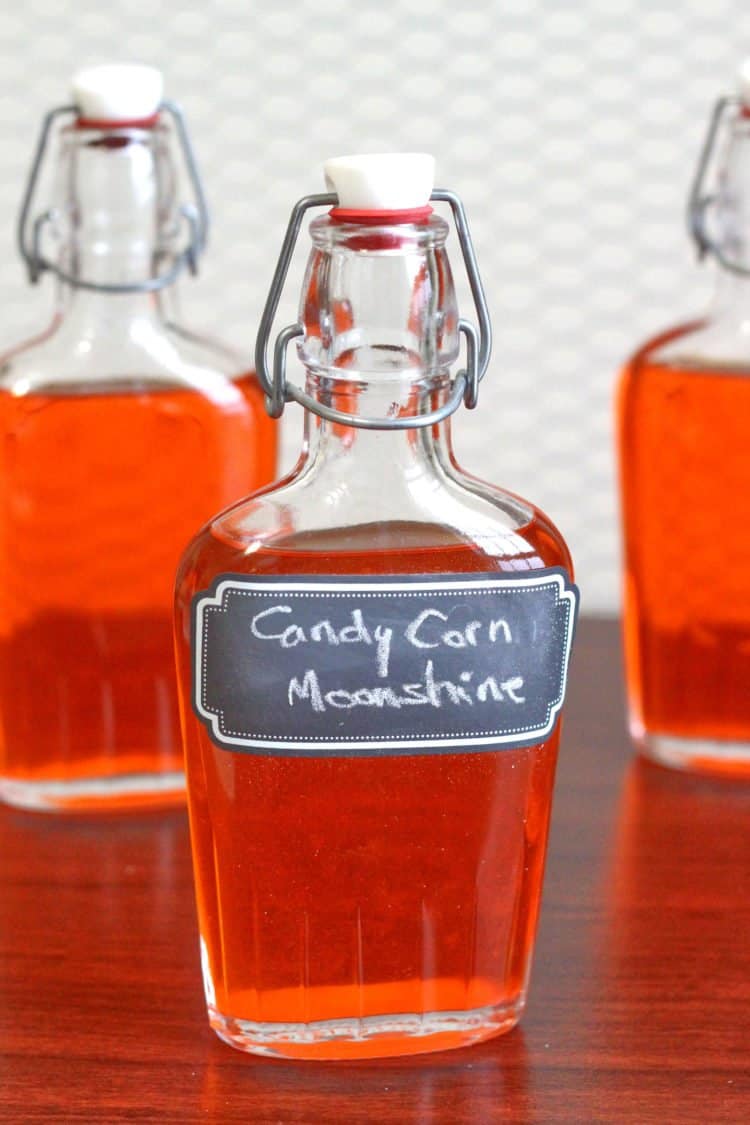 Candy Corn Moonshine infusion in glass flasks