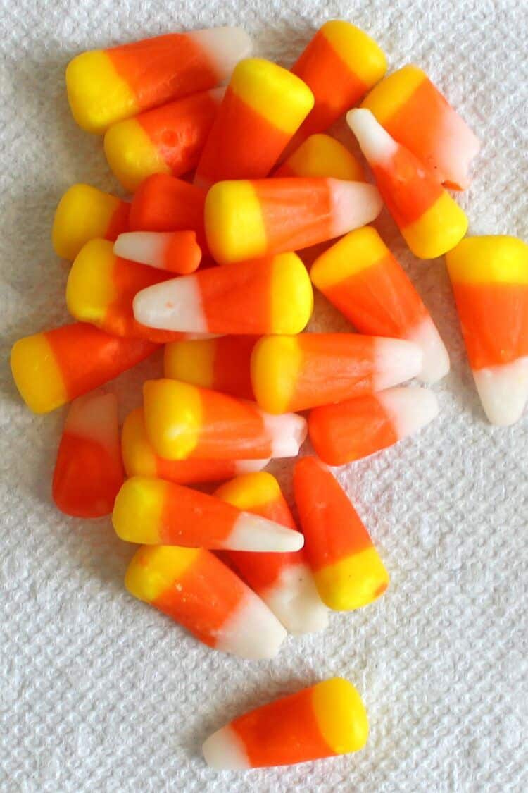 Candy corn laying in a pile on a paper towel