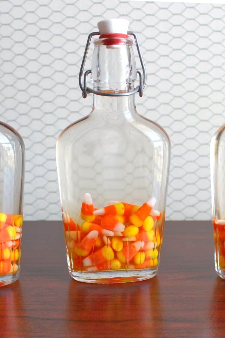 Candy corn in flasks with moonshine