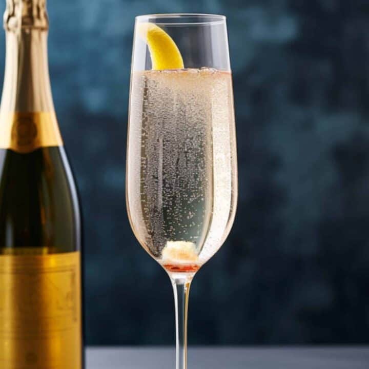 Champagne Cocktail in flute glass with sugar cube melting in bottom