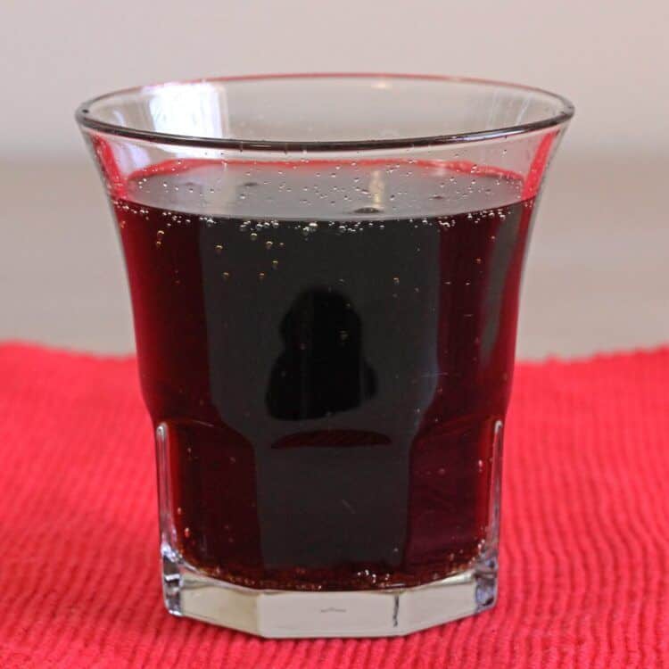 Closeup of Cherry Coketail drink sitting on red placemat