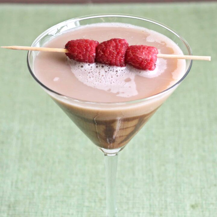 Chocolate Raspberry Martini with chocolate drizzle in glass and raspberry garnish