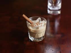 Cinnamon Caramel Apple cocktail in rocks glass on wooden table