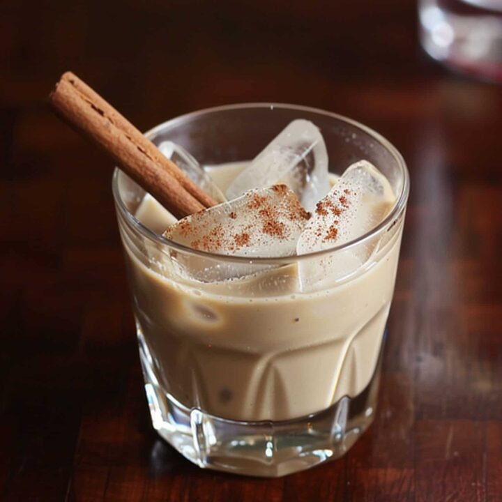 Cinnamon Caramel Apple cocktail in rocks glass on wooden table