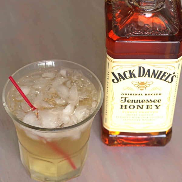 Overhead view of Club Honey cocktail beside bottle of Jack Daniel's Honey