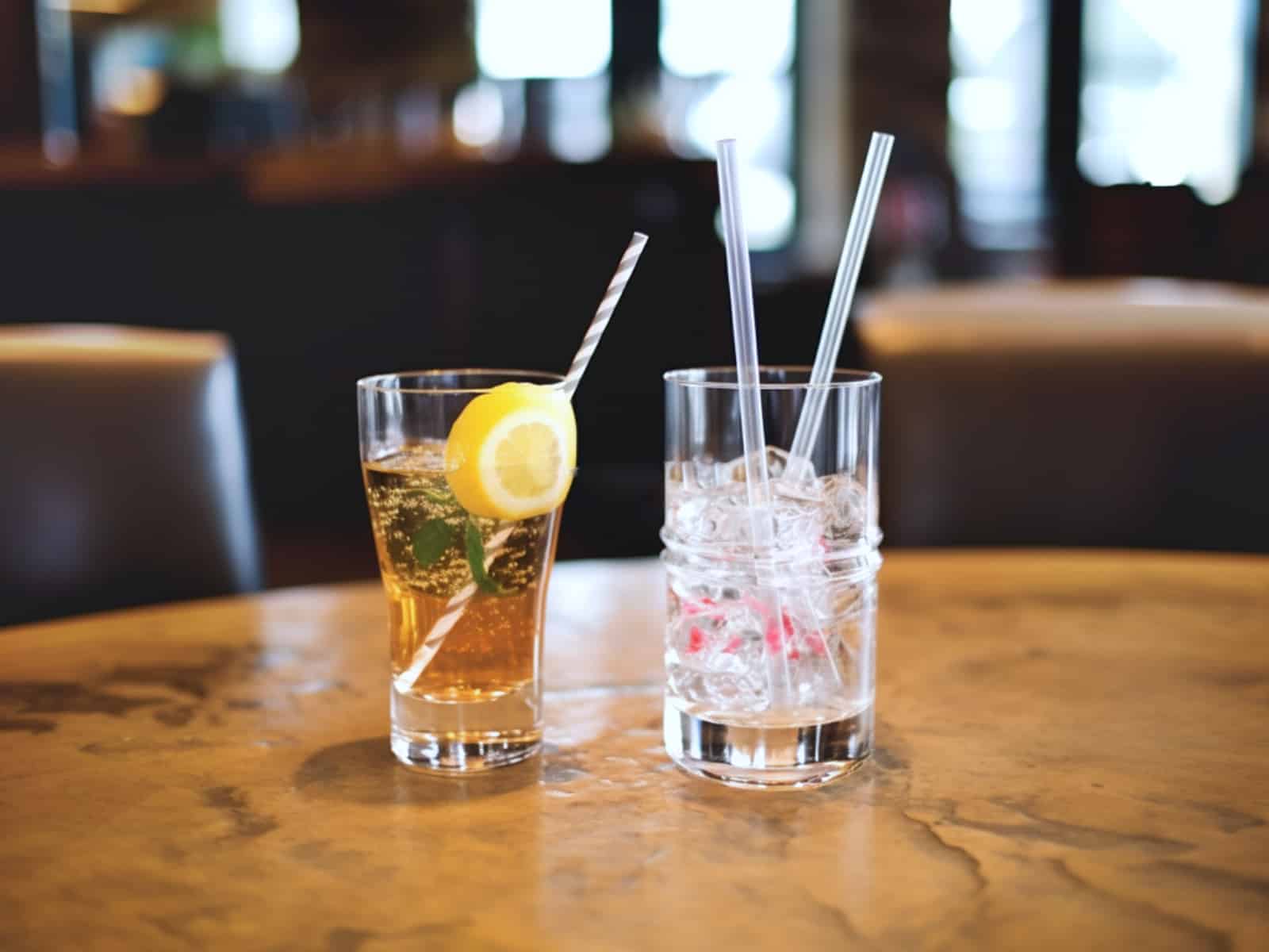 Cocktails with eco-friendly straws in glass and paper