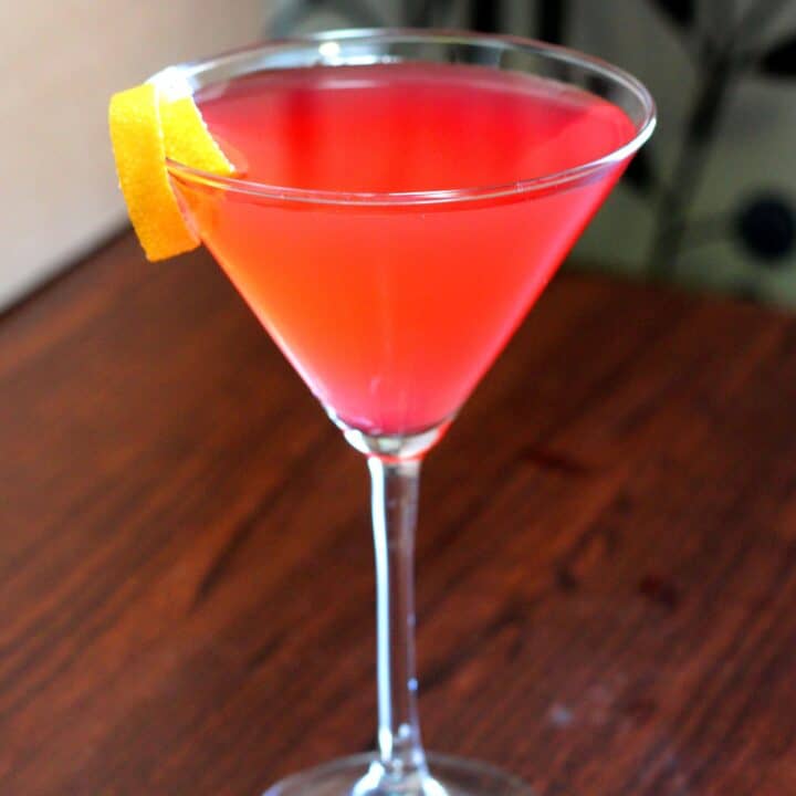 Cosmopolitan cocktail on bar with lemon twist