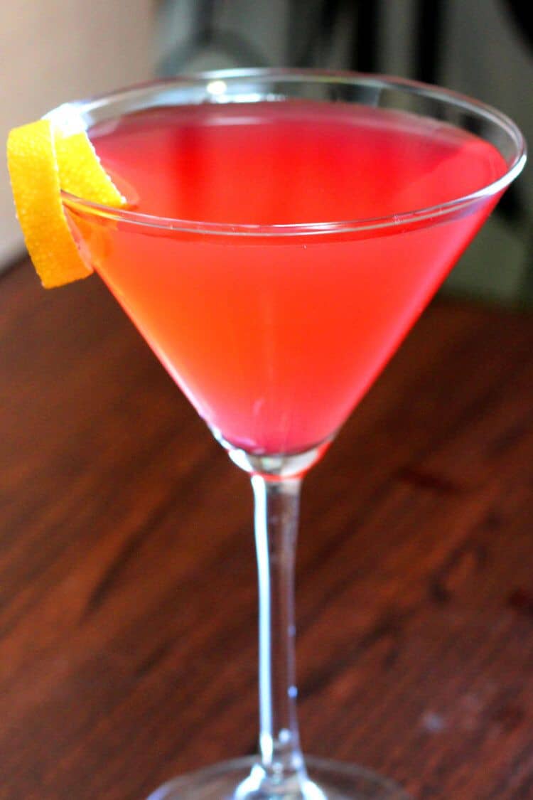 Cosmopolitan cocktail on bar with lemon twist