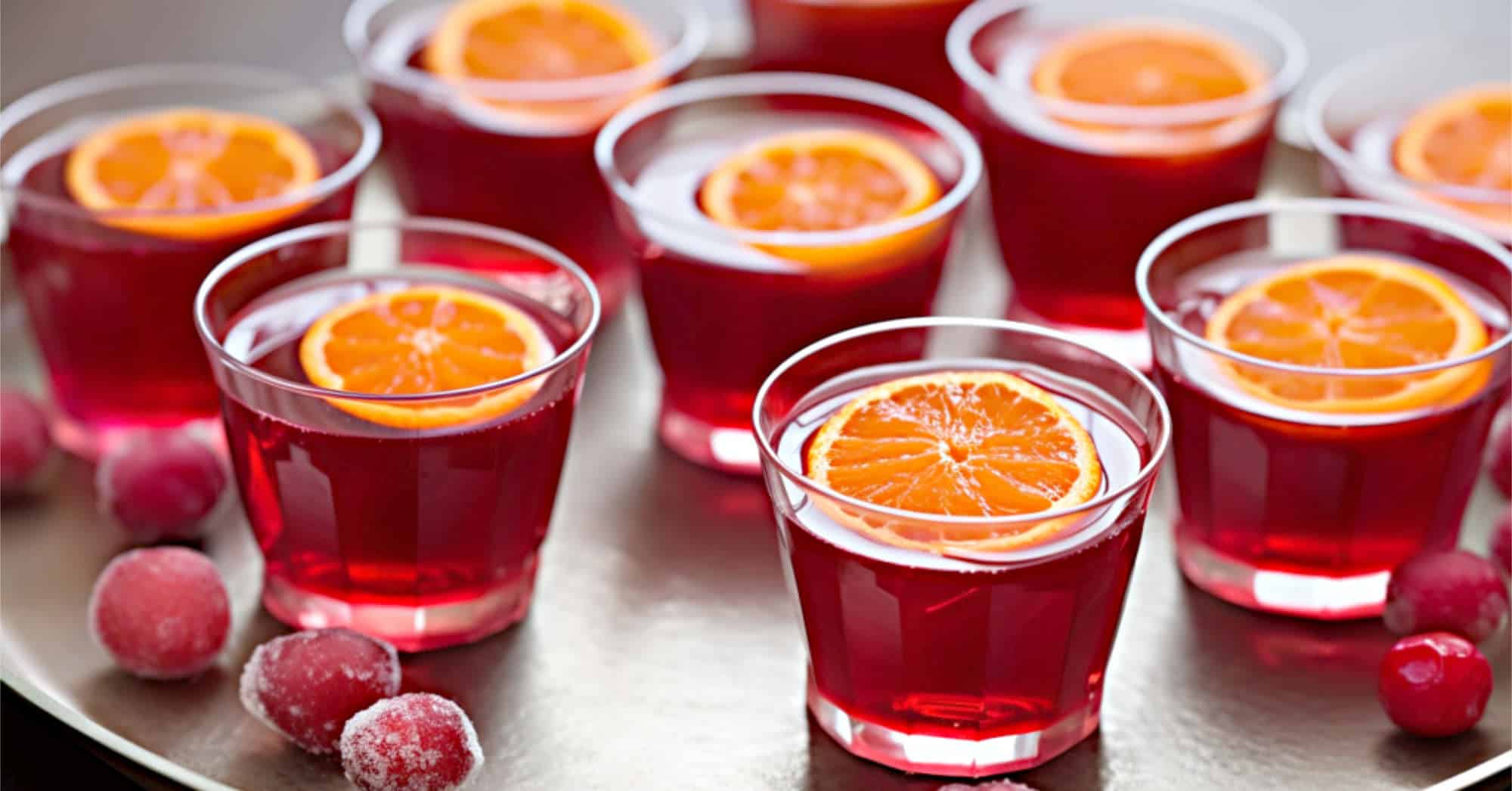 Cranberry Apple Orange Jello Shots with tangerine slice on top