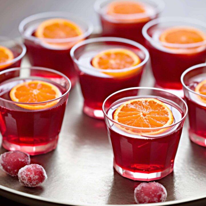 Cranberry Apple Orange Jello Shots with tangerine slice on top