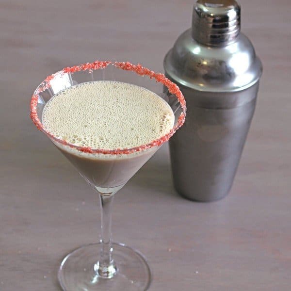 Closeup of Creamy Chocolate Raspberry cocktail in front of shaker on table