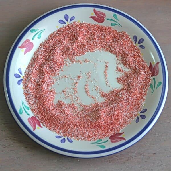 Pile of red sugar on a saucer