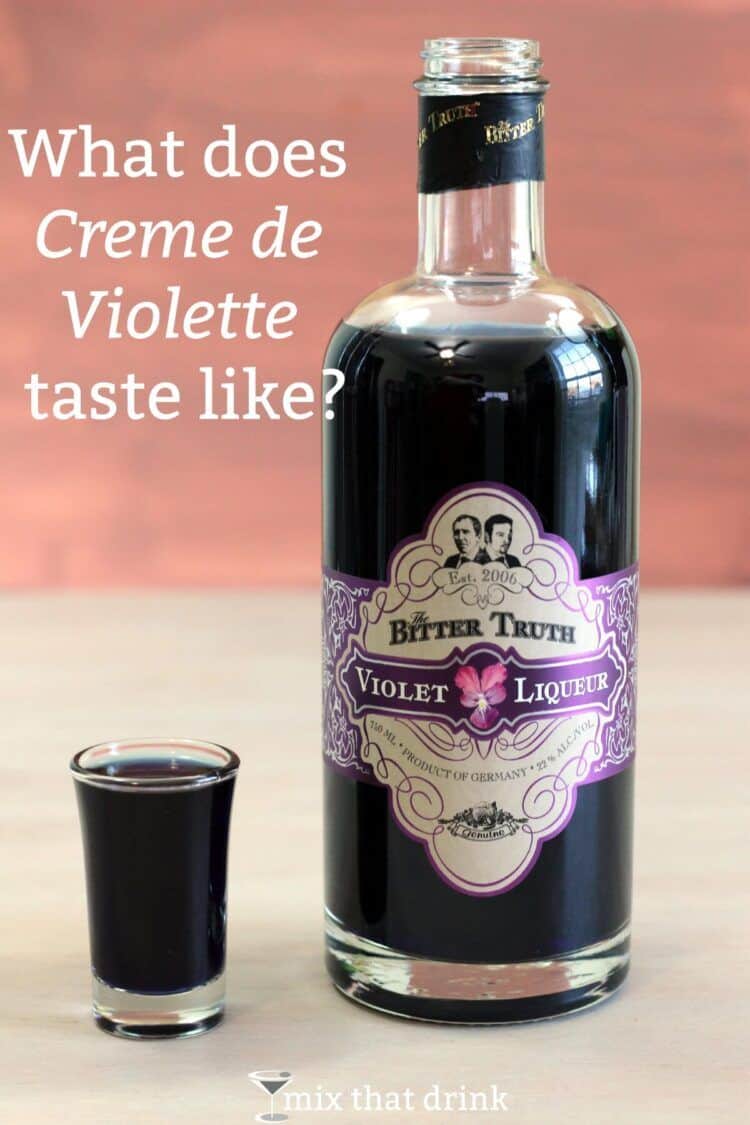 Bottle of Creme de Violette next to shot glass of same