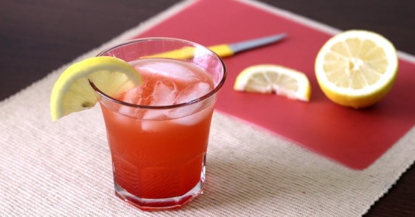 Crystal Cranberry drink with lemons on cutting board