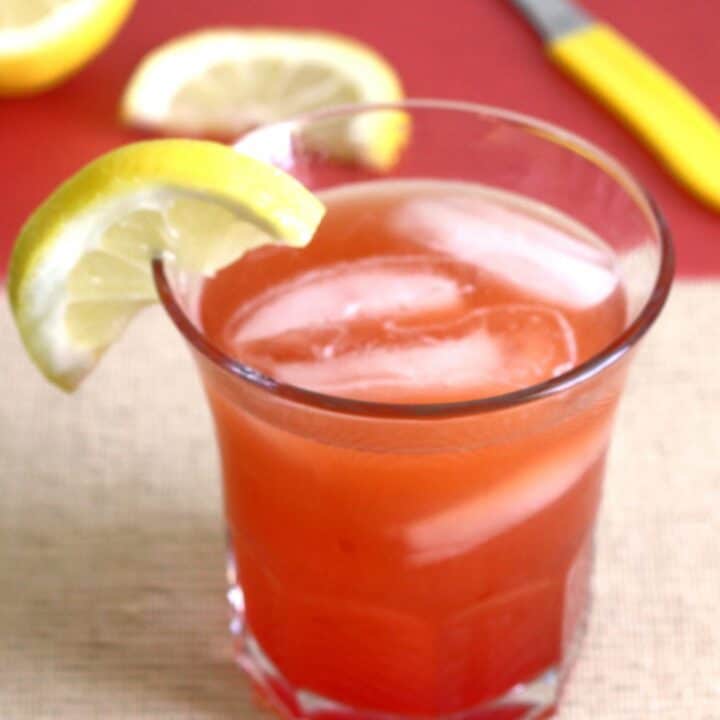 Crystal Cranberry drink with lemons on cutting board