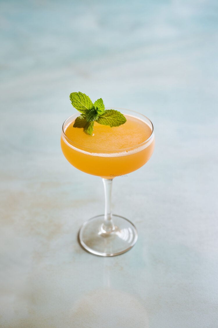 Cuban Cocktail in coupe glass with mint sprig