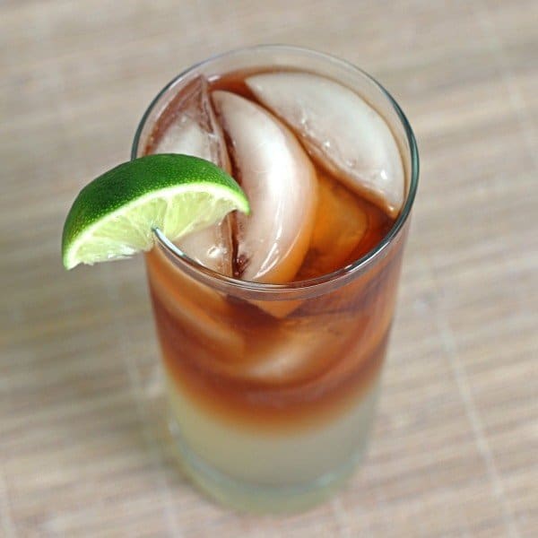 Overhead view of Dark 'n' Stormy cocktail with lime wedge