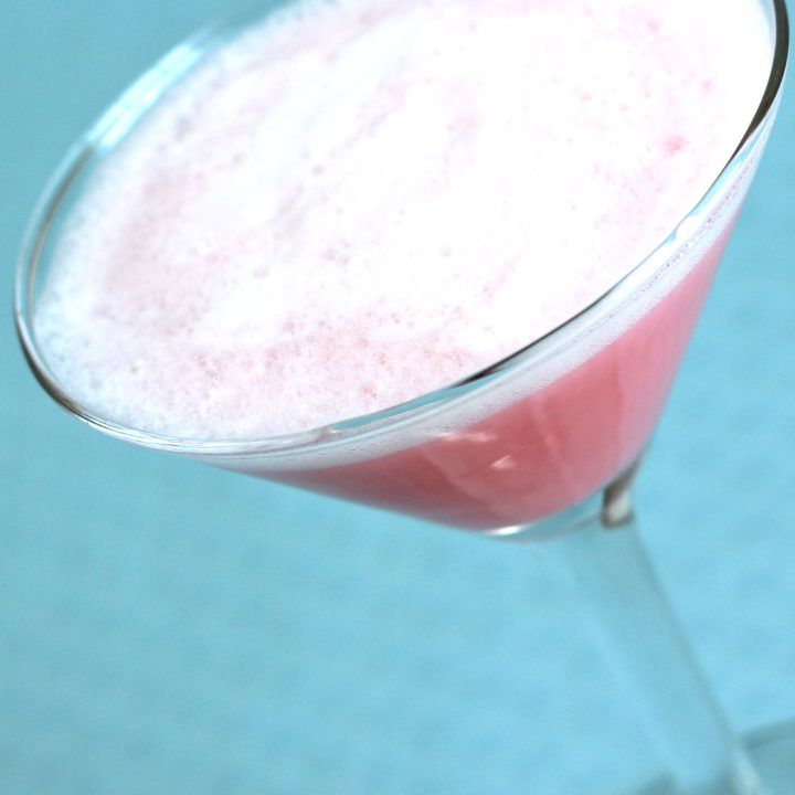 The Fairy Belle Cocktail is a pink gin cocktail, with apricot brandy, grenadine and egg white. It has a silky texture and a sweet berry flavor. It's just what you might have imagined from the name.