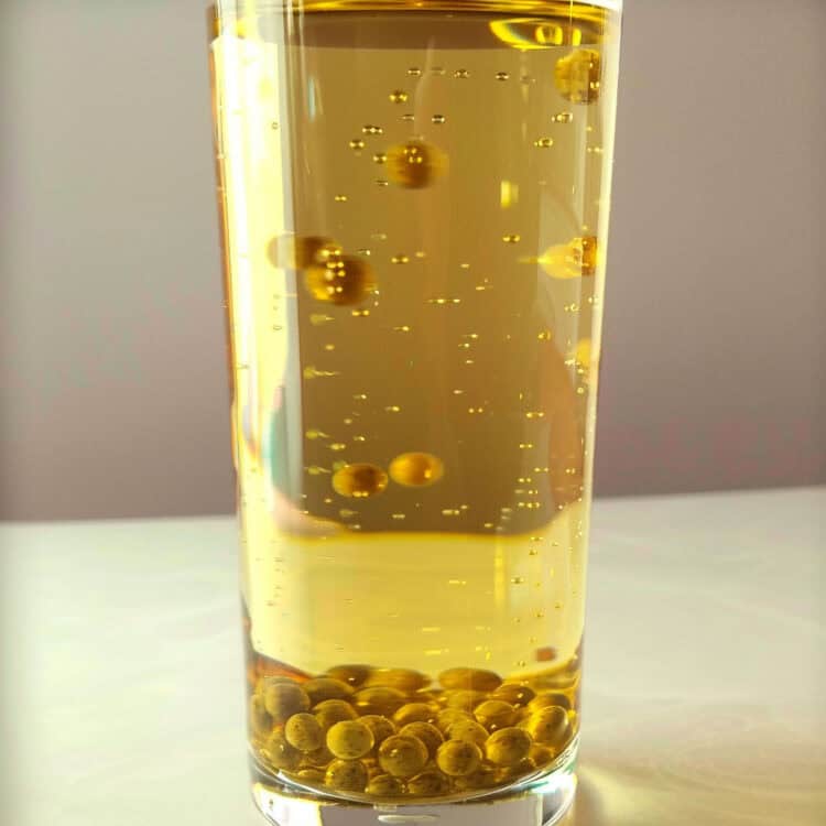 Rum Caviar balls forming at bottom of oil in glass