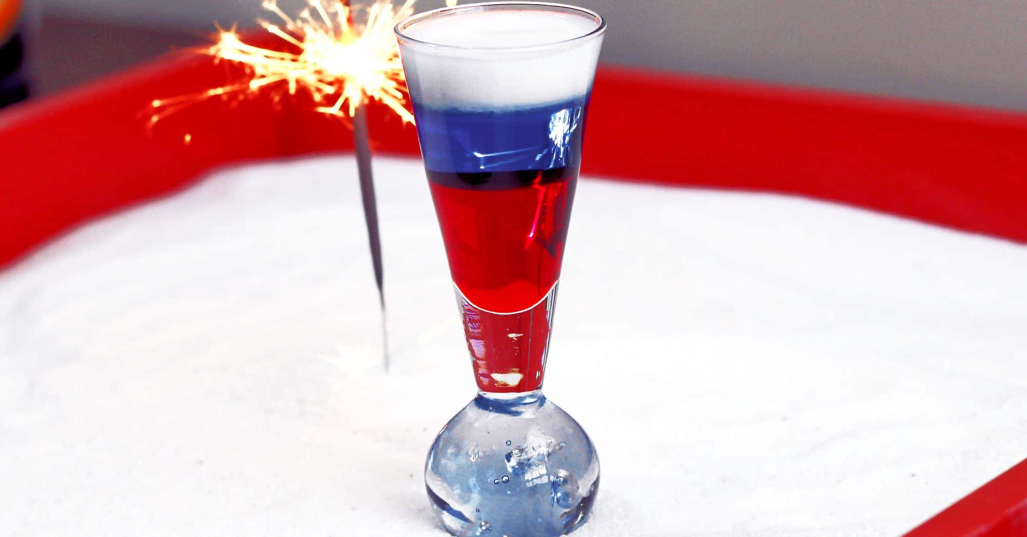 Fourth of July layered cocktail with sparkler