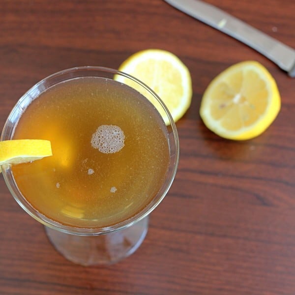 Overhead view of Frisco Sour drink on table with lemon halves