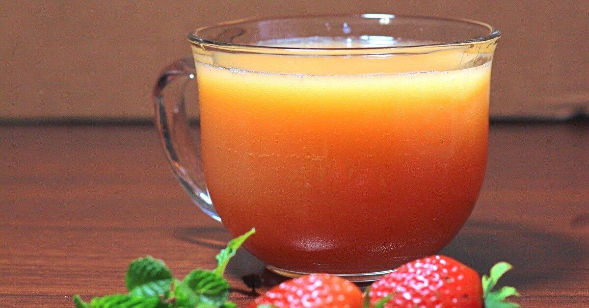 Gabbie's Punch in glass on table with strawberries