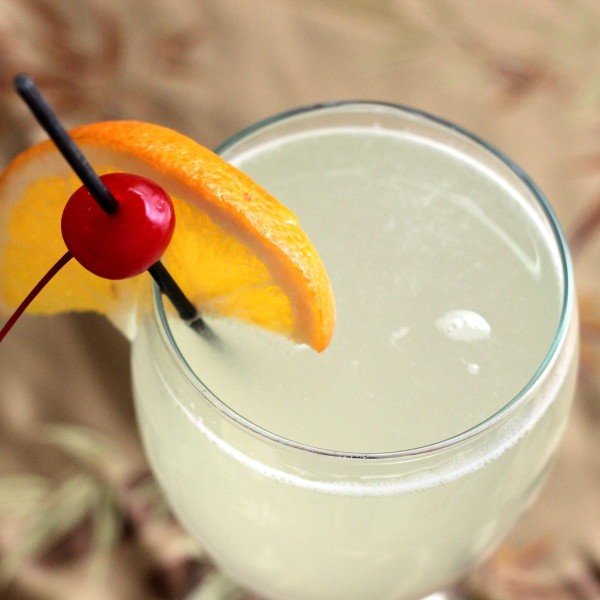 Overhead view of Gin Sour drink with cherry and orange