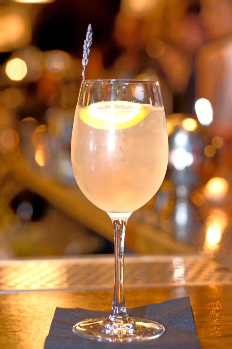 Highline Spritzer on bar top with sprig of lavender