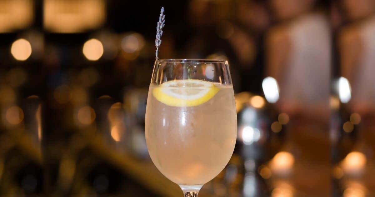 Highline Spritzer on bar top with sprig of lavender