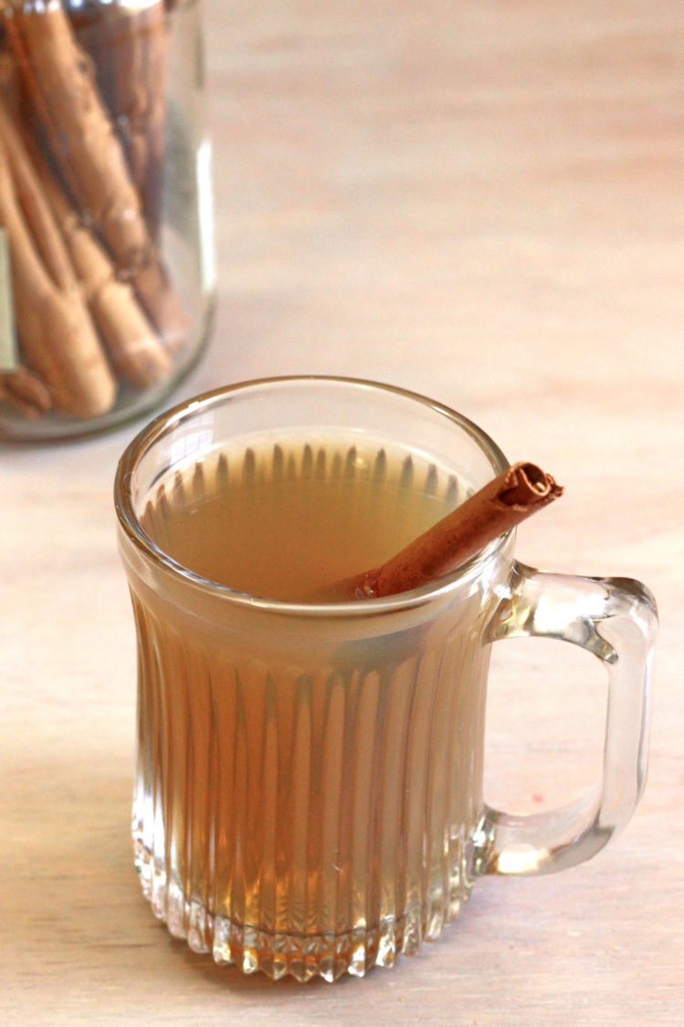 Hot Buttered Rum in front of jar of cinnamon sticks