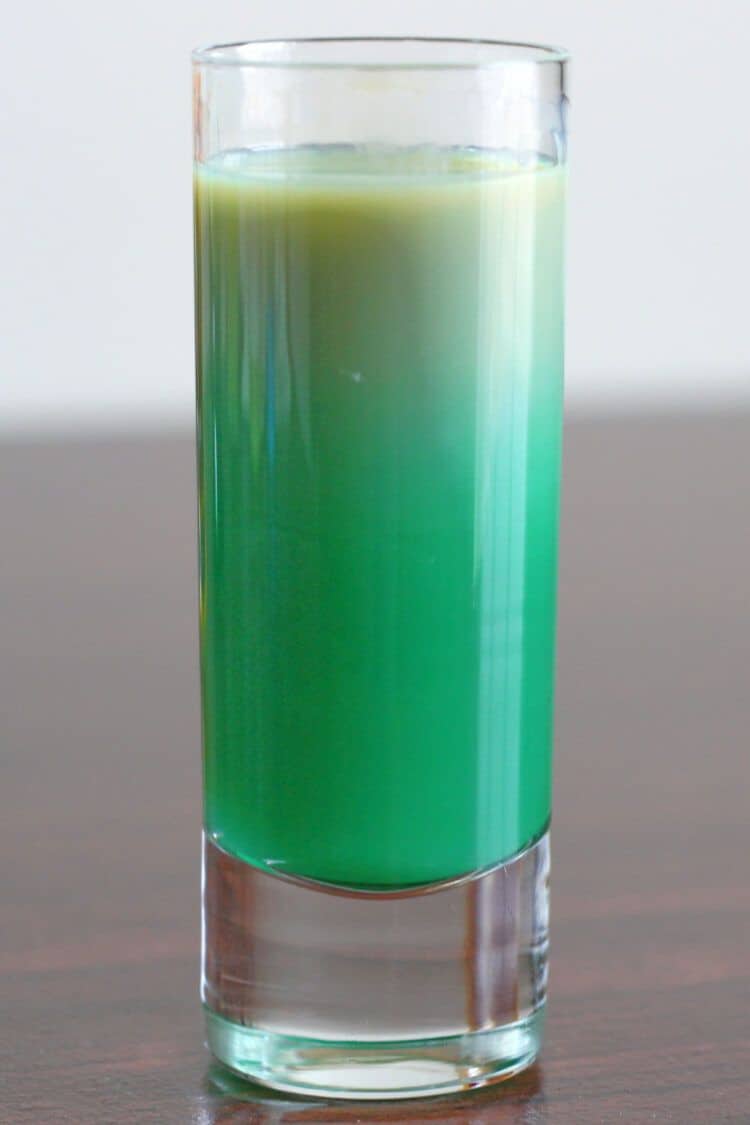 Green Irish Flag shot drink stirred to obliterate layers