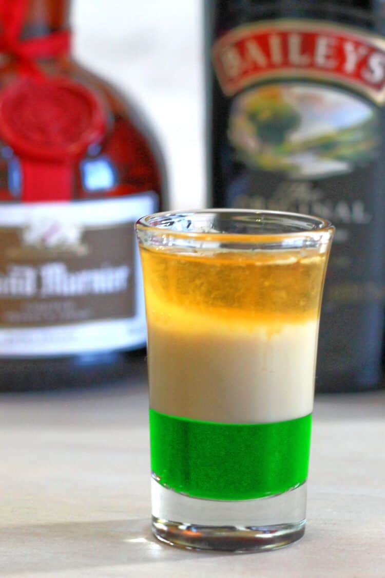 Irish Flag shot drink sitting in front of liquor bottles