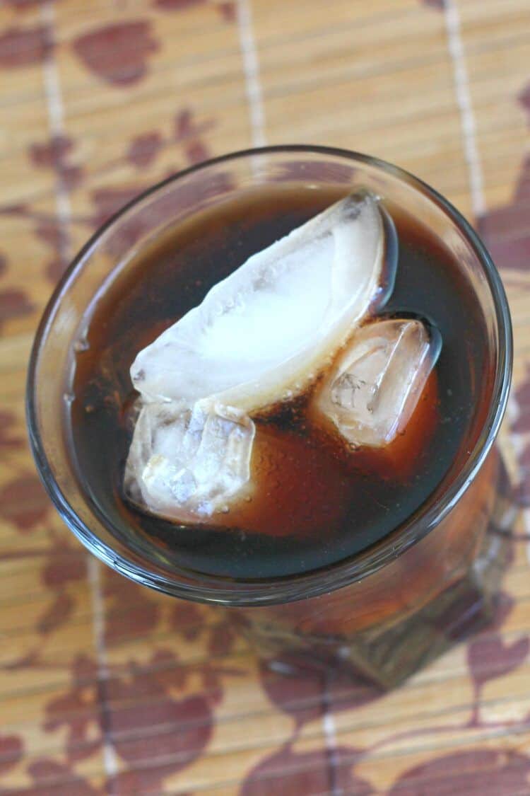 Angled overhead shot of Jack and Coke drink on patterned placemat