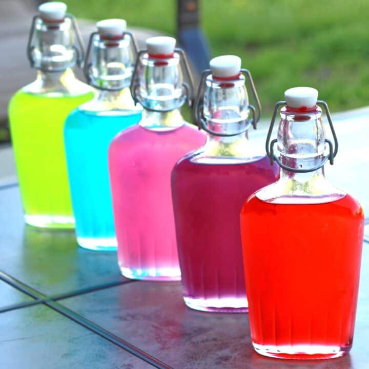 Jolly Rancher Vodka in flasks on a patio table