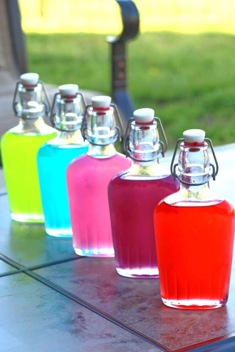 Jolly Rancher Vodka in flasks on a patio table